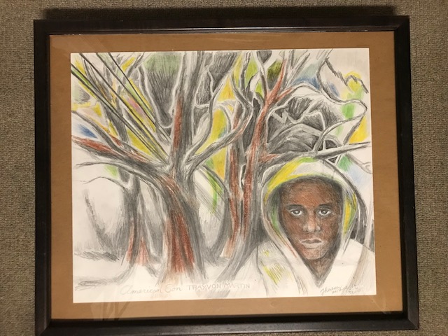 18.	Trayvon Martin by Theresa Reuter, Baltimore artist.  Color pencil, frame 21” wide x 18” tall.  Original condition.  Starting bid $70 Increase by $5.
