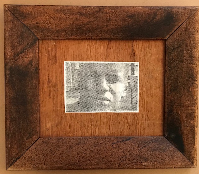 19.	Freddie Grey by Theresa Reuter, Baltimore artist.  Newspaper photo on 2 shades of skin tone brown, wooden frame 16”x16”.  Original condition.  Starting bid $60 Increase by $5.