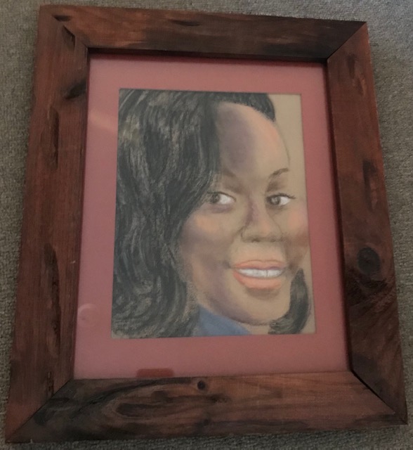 20.	Breonna Taylor by Theresa Reuter, Baltimore artist.  Pastel on paper, wooden frame 15”x18”.  Original condition.  Starting bid $60 Increase by $5.