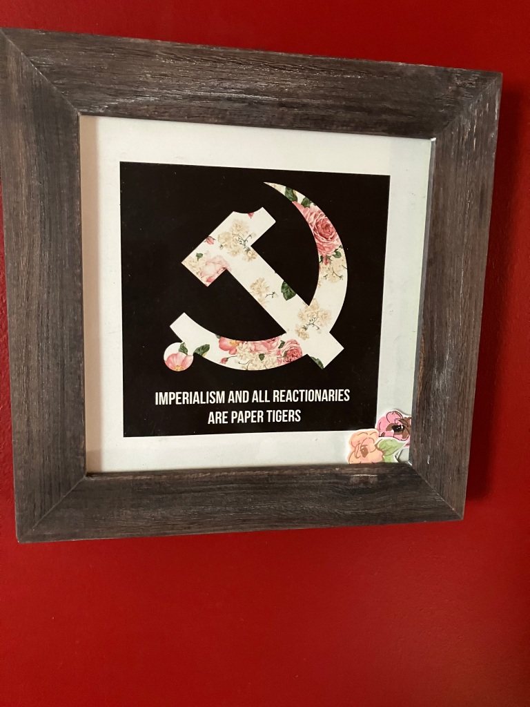 25.	Collage of Hammer and sickle with flowers, frame 10 ½”x10 ½”.  Mint condition.  Starting bid $40 Increase by $5.